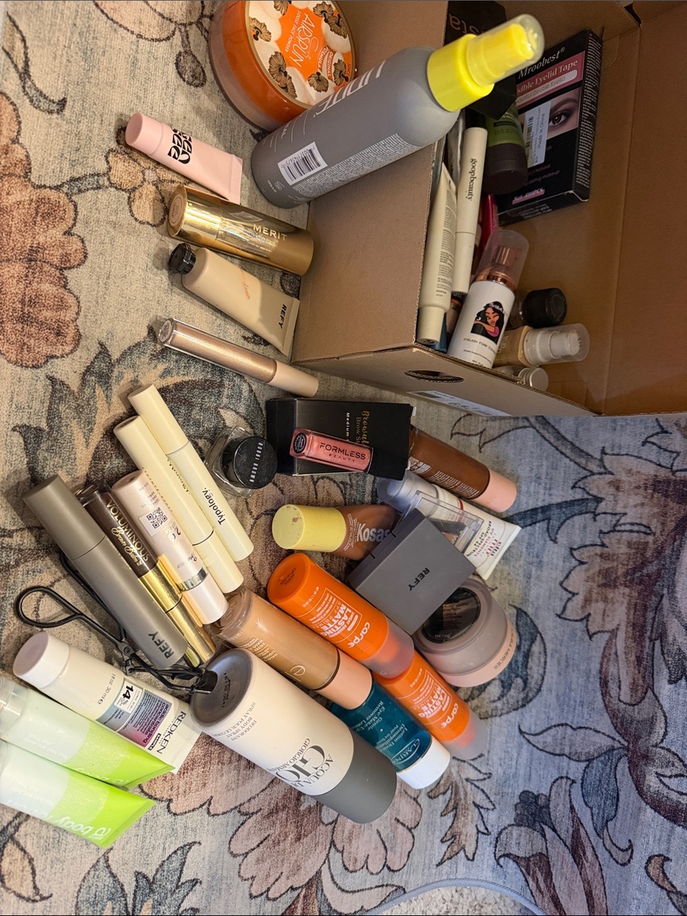 Assorted Women's Makeup Essentials in Neutral and Orange Shades